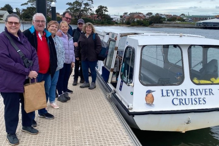 a group of people standing in front of a boat
