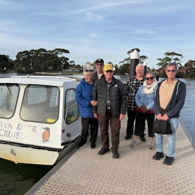 a group of people standing next to a body of water